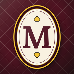 Manuzzio icon: the medallion with the “M” on the burgundy lattice of the card back.